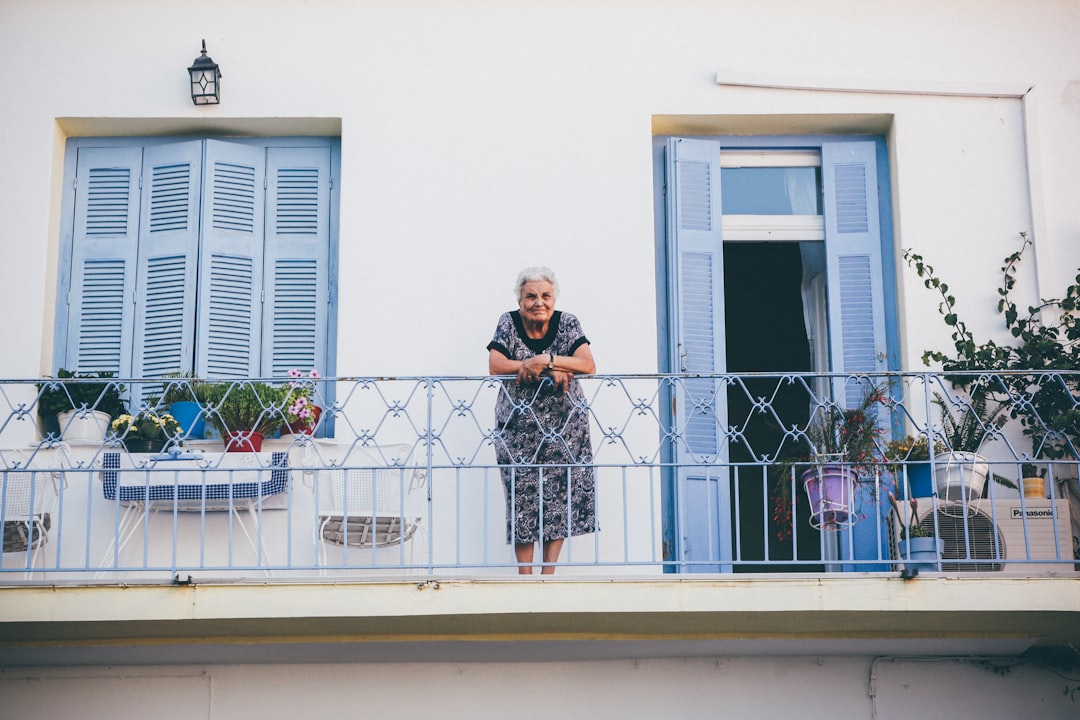 Person standing by a steel railing overlooking the sea