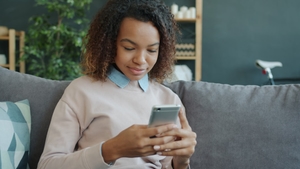 Détente sur le canapé en créant une carte postale sur smartphone