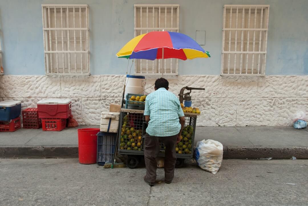 Straßenhändler neben einem Auto in Bogotá, Kolumbien.